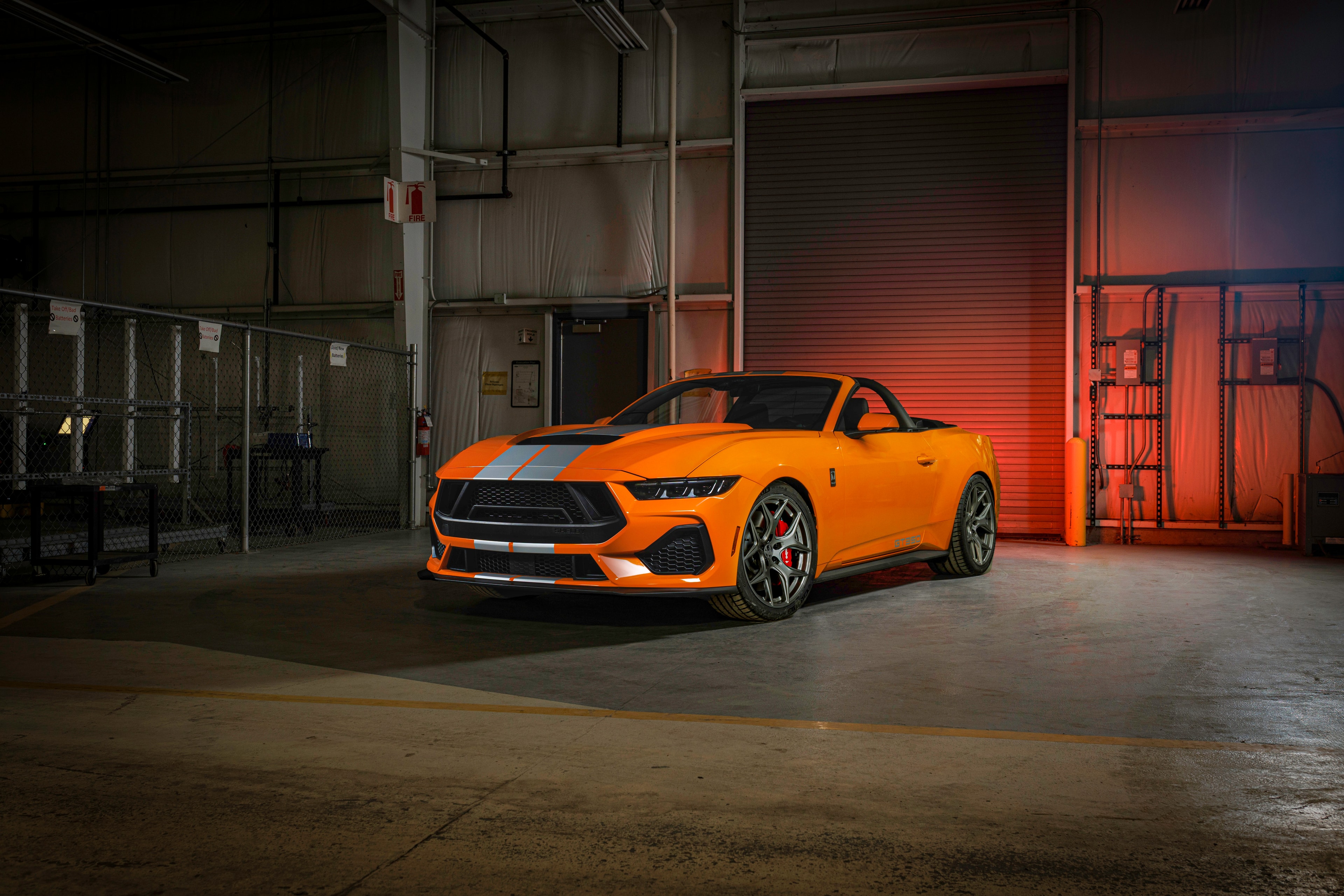 2026 Shelby GT350 orange convertible front 3/4 red-lit garage