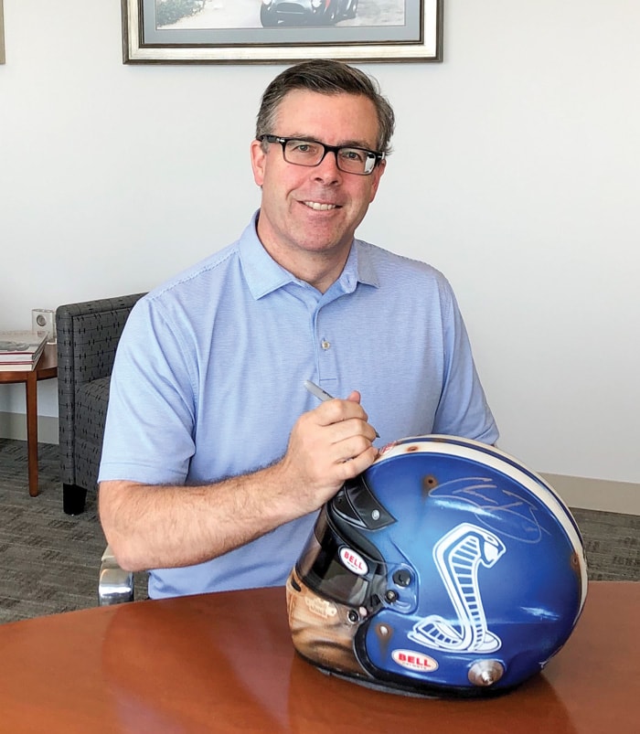 Aaron Shelby holding a racing helmet